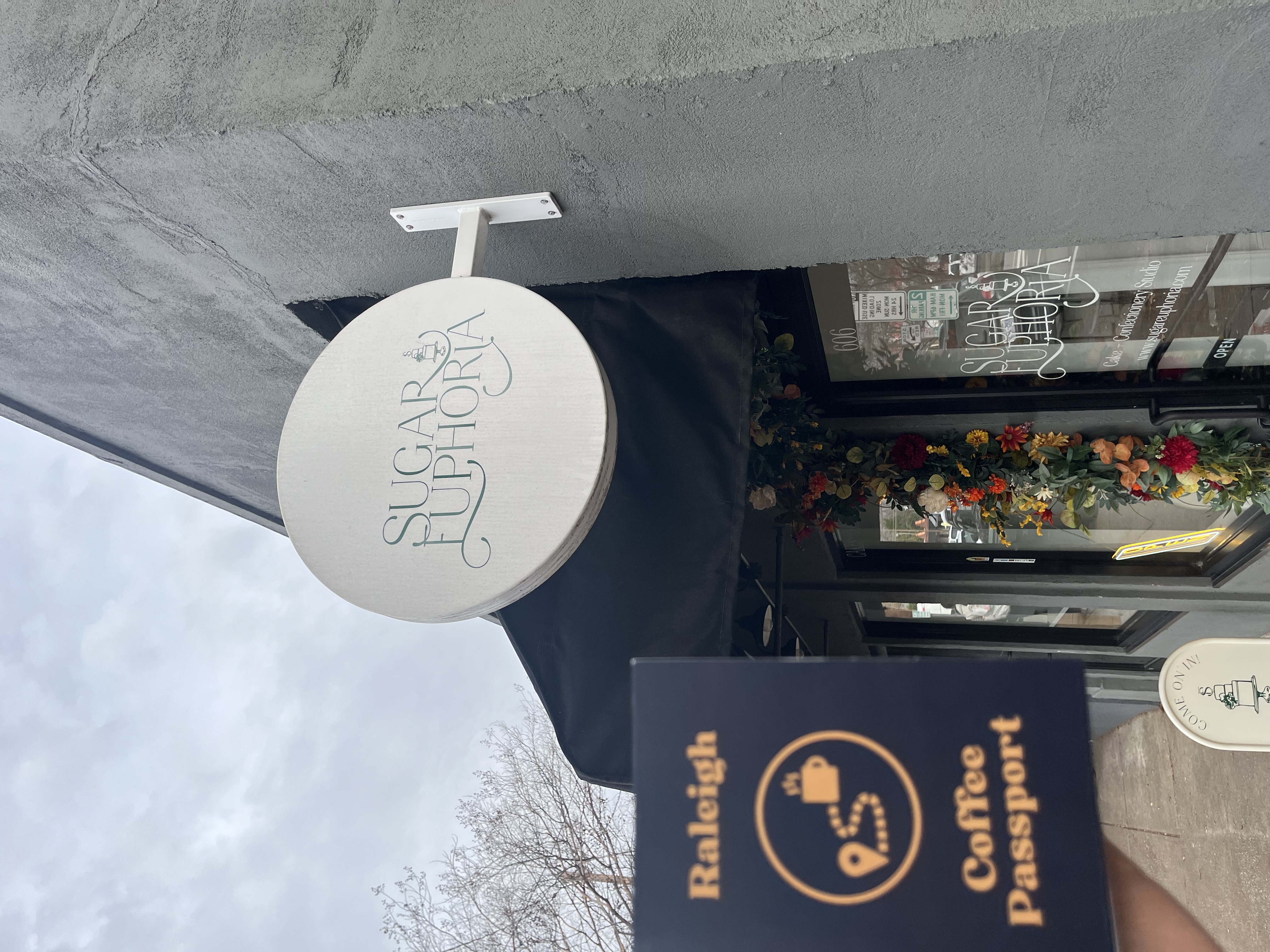 Raleigh Coffee Passport in front of Sugar Euphoria