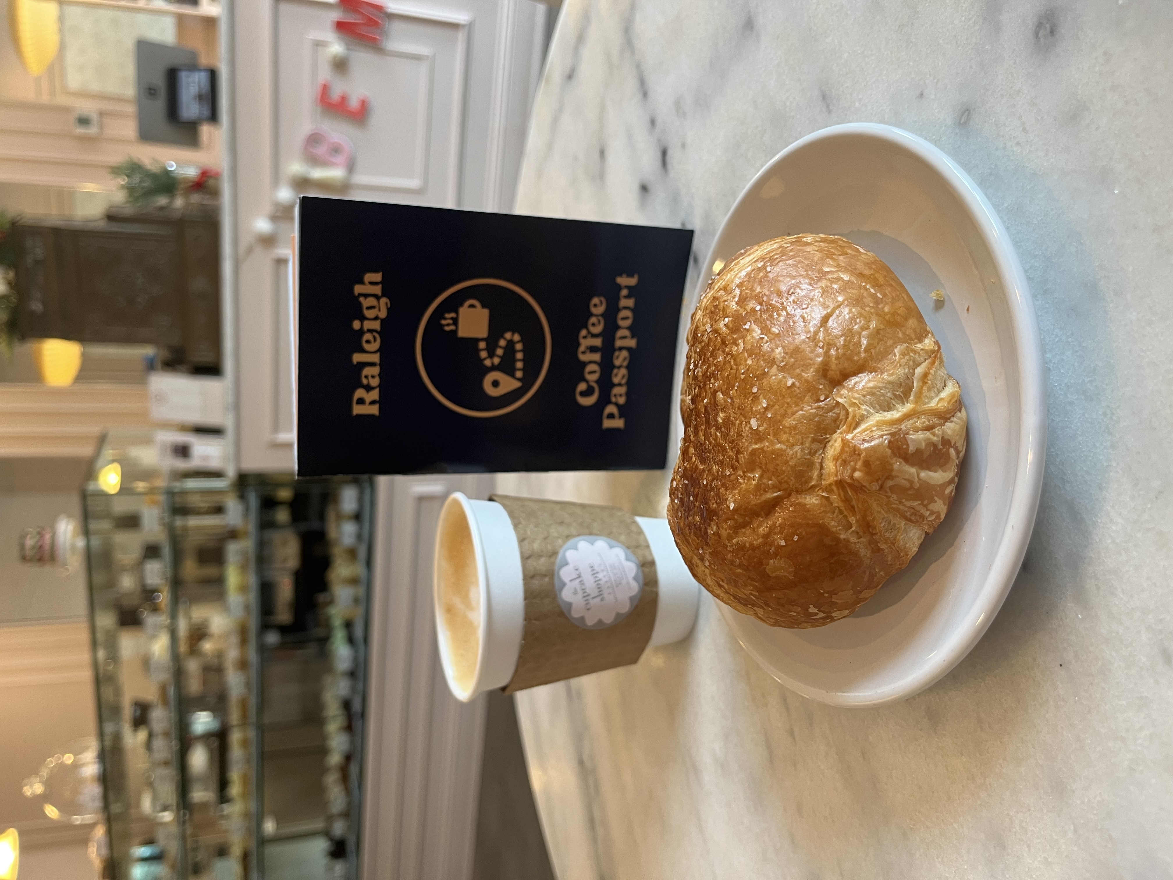 Raleigh Coffee Passport and a drink and a pastry